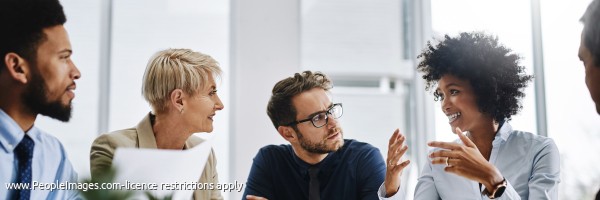 Shot of a group of businesspeople sitting together in a meeting