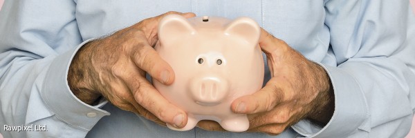 Senior man holding piggy bank for financial savings campaign